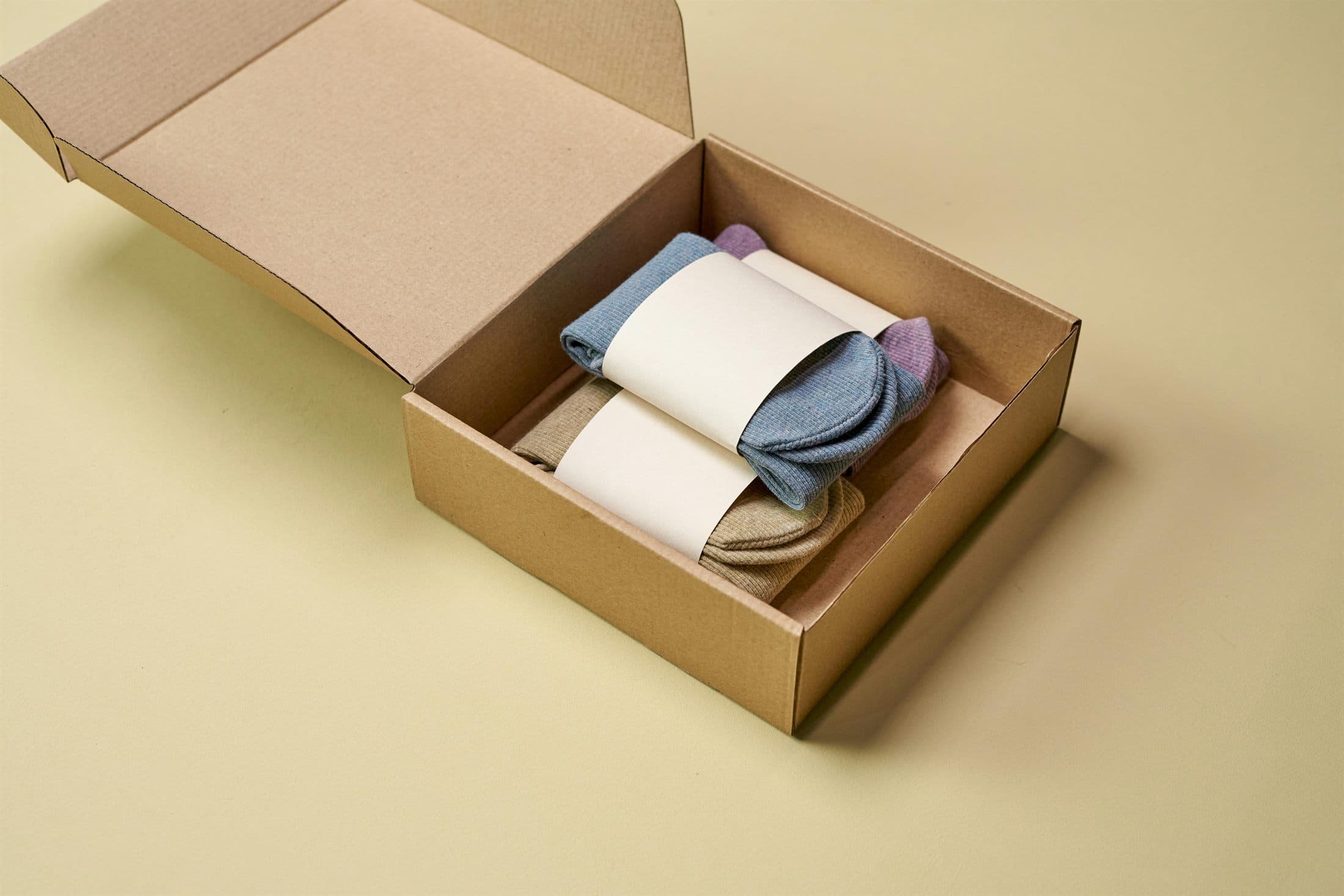 Folded socks arranged in a retail-ready cardboard packaging box